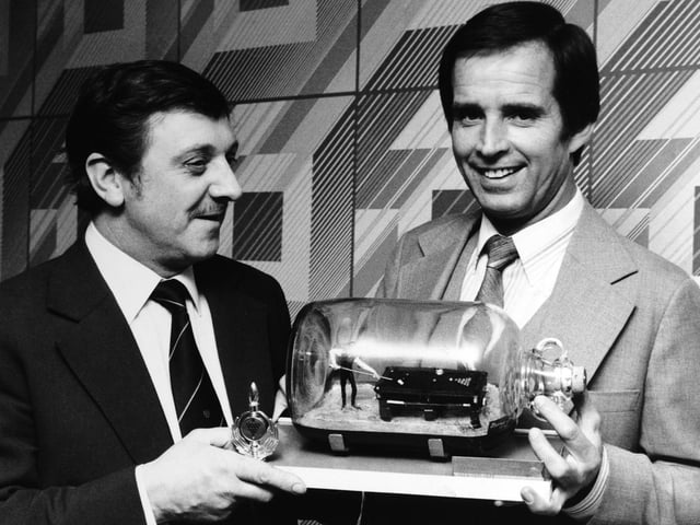 Former world snooker champion John Spencer, right, was presented with a snooker player in a bottle by its creator Barrie Dale on a visit to St. Anne's Social Club in February 1980.