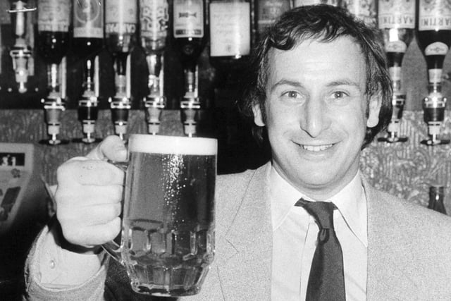 Cheers! Len Cohen, licensee of the Yorky Bar on York Place in the city centre holds up a celebratory pint of Hansa Lager in July 1980.