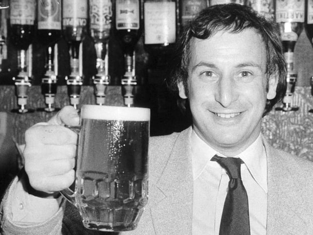 Cheers! Len Cohen, licensee of the Yorky Bar on York Place in the city centre holds up a celebratory pint of Hansa Lager in July 1980.