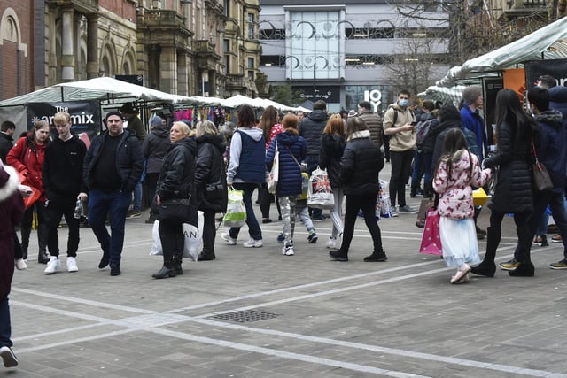 Shoppers browse a market on Albion Place