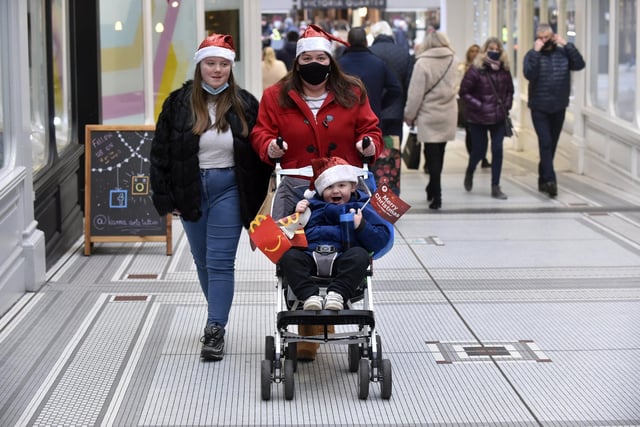 Shoppers sporting Santa hats visit Leeds' shopping arcades
