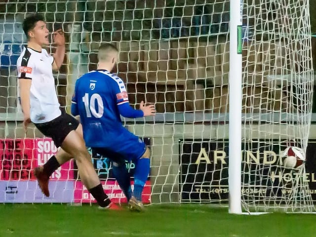 Bradley Fewster sees the ball across the line from Jacob Hazel in the 3-0 home win for Whitby Town against Grantham Town.
Photo by Brian Murfield