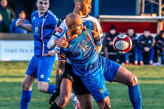 Whitby Town top scorer Jacob Hazel holds off a Grantham Town player in their 3-0 home win.

Photo by Brian Murfield