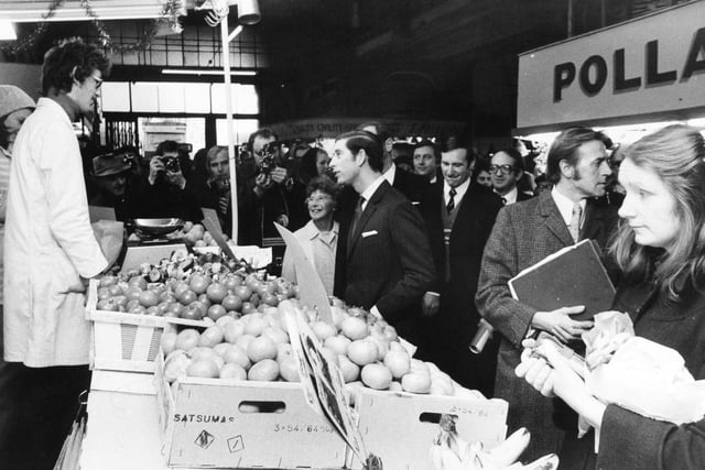 The Prince of Wales chats to a greengrocer in fire-hit Kirkgate Market during his walkabout in December 1975.