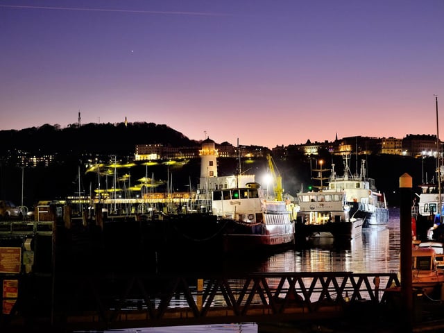 Night falls on Scarborough harbour.