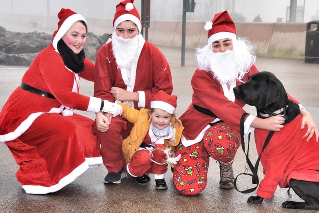 Morecambe Santa Dash. Helen Hague, Harvey Hague (14), Abby Hague, Bella Gaskell (3) and Lily Boo the dog. Picture by Julian Brown /JPIMedia 19/12/21