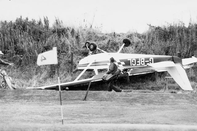 A golfer walks past a Cessna 152 which overshot the runway at Leeds Bradford Airport in September 1981. The pilot, Norman Hudson, was unhurt.