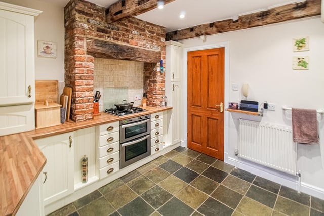 Exposed beams and bricks add to the kitchen character.
