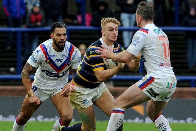 Alex Sutcliffe, now of Castleford Tigers, takes on two Wakefield players in 2019.