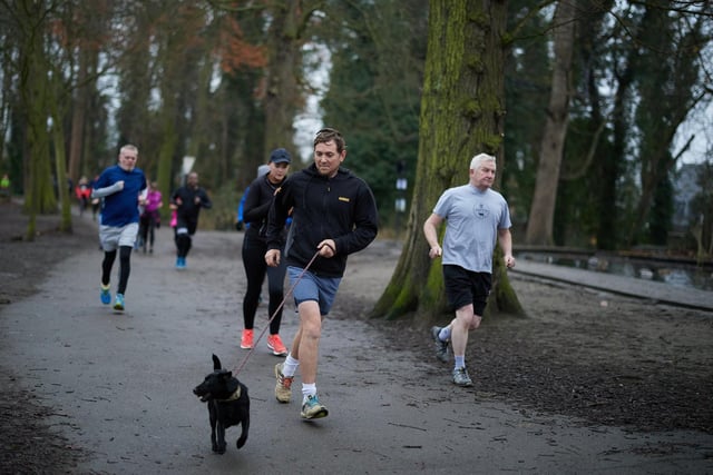 This dog joins his owner in the parkrun.