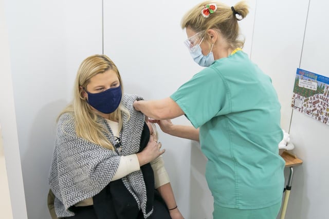 Dr Jane Bentley (right) administers a booster coronavirus vaccine to Emma England (left)