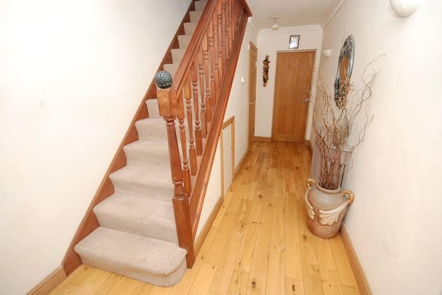 A welcoming hallway with staircase leading t the first floor.