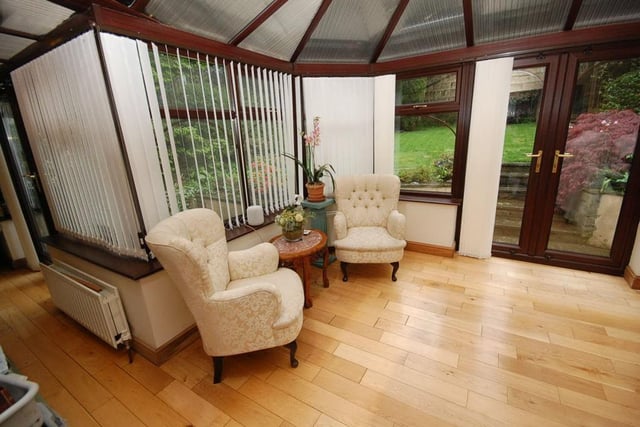 Doors open out to the garden from this attractive conservatory, or garden room.