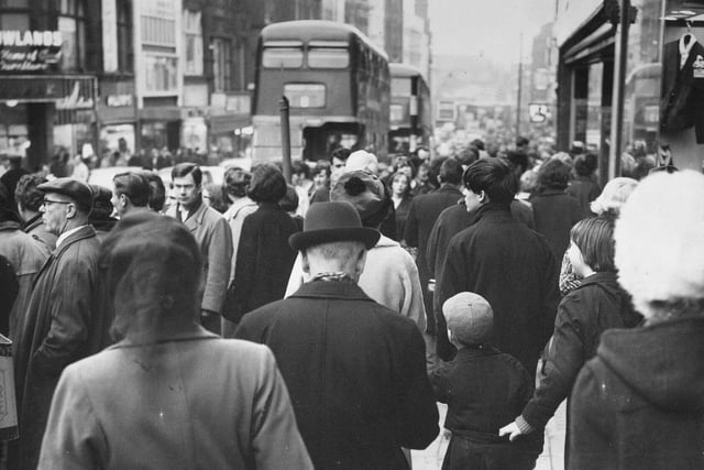 Briggate in December 1965 packed with slowly moving Christmas shoppers.