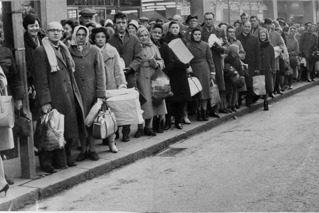 Shoppers laden with the fruits of battle queue on Briggate for the bus home on Christmas Eve in 1962.