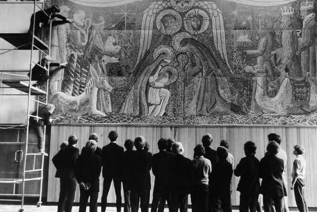 A line of St. John Bosco School pupils look at a giant mosaic of the nativity in December 1969 which had been made of coloured pieces of paper cut from magazines and foil from cigarette packs. The mosaic measuring 24ft by 12ft, was designed and made by pupils at the school on Tongue Lane in Meanwood.