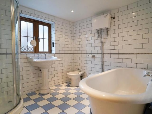 The stylish bathroom, with free standing bath and shower cubicle.