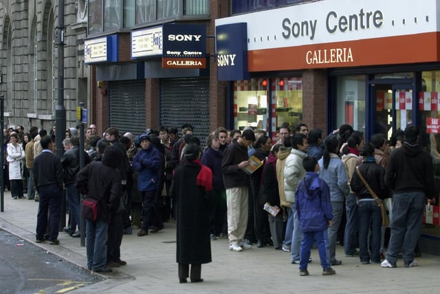 Shoppers wait outside the Sony Centre in Leeds city centre for the doors to open for the sales on Boxing Day in December 2003.