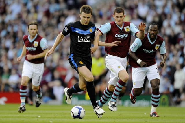 Chris McCann of Burnley chases Michael Carrick of Manchester United during the Barclays Premier League match between Burnley and Manchester United at Turf Moor on August 19, 2009 in Burnley, England.