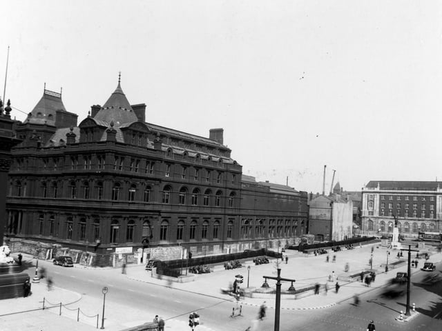 The Headrow past the junction with Calverley Street and Cookridge Street in May 1940. The central library, museum and war memorial are shown.
