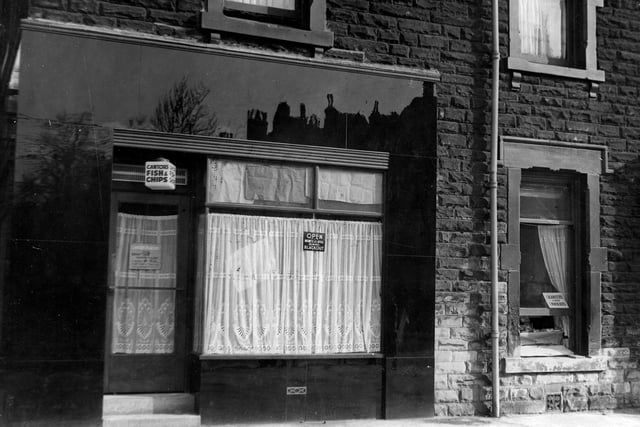 Cantors fish & chip shop on Chapeltown Road in October 1940. Sign in window states Open business as usual during blackout. House on right appears to be selling cigarettes and chocolate through an open window.