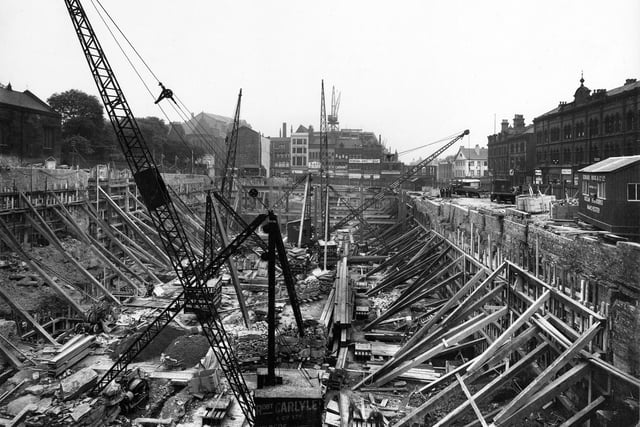 The Headrow (this part was formerly known as Upperhead Row) looking east, showing the construction site of the store in July 1931. The site was bought for £160,000 and the area was cleared of several old yards and many properties between the Headrow right and Mark Lane, to the left.