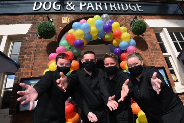 YEAR IN PICTURES 2021  - WIGAN
Celebrating entertainment venues allowed to open after months of lockdown and Covid restrictions in May.  Staff at  Dog and Partridge, Wallgate, Wigan, welcome customers with open arms after months of Covid restrictions.