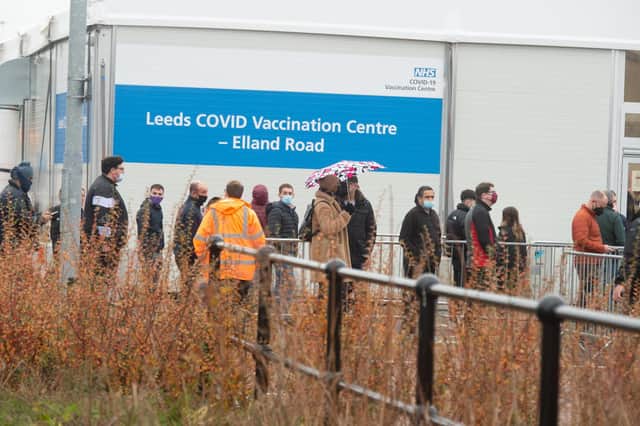 People queue to enter the Leeds Vaccination Centre at Elland Road