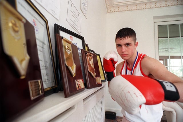 National Schools Boxing champion Jimmy Fletcher with some of his awards at his home in Pudsey in March 1999.