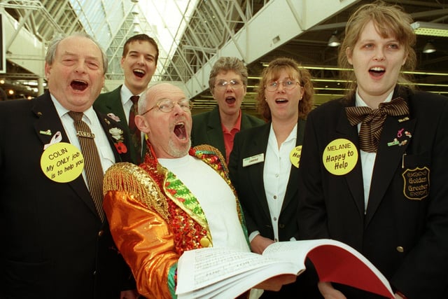 David Owen-Lewis from Opera North teaches Adsa 'greeters' some songs to welcome their customers at the Pudsey store in November 1998.