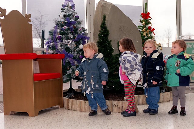 Christopher Wilson, Emily Underwood, Andrew and Emily Wilson look expectantly at Santa's chair at Asda Owlcotes in Pudsey. The store had advertised for a Father Christmas but so far they have yet to find one.