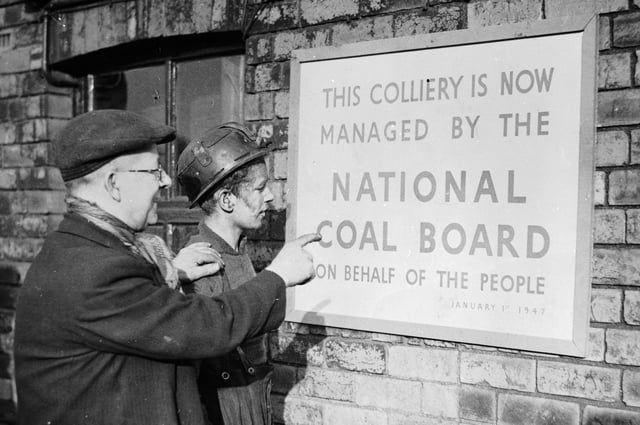 2nd January 1947:  Two miners reading a notice announcing that their colliery is.. 'Now managed by the National Coal Board on behalf of the People'.