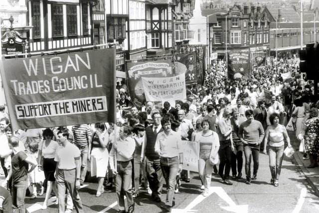 Striking miners and their supporters march up Standishgate, Wigan, on Saturday 9th of June 1984.