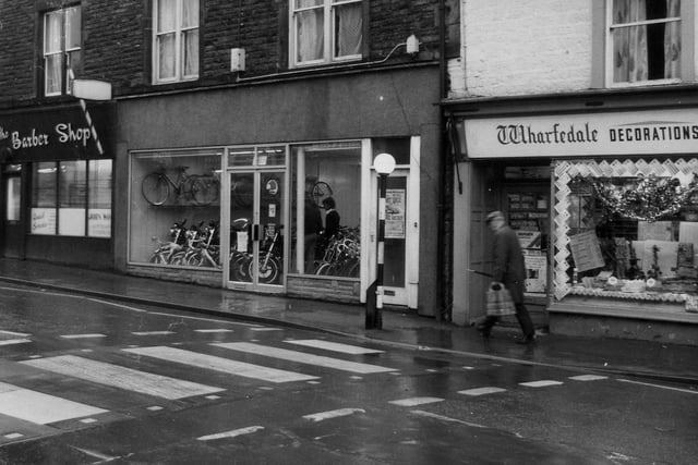 The north side of Boroughgate in 1976. On the left is John Wood's barber shop, then Ray Dell motorcycles and Wharfedale decorations, wallpaper and paint. Despite listed building status at the time, the latter was subsequently demolished.