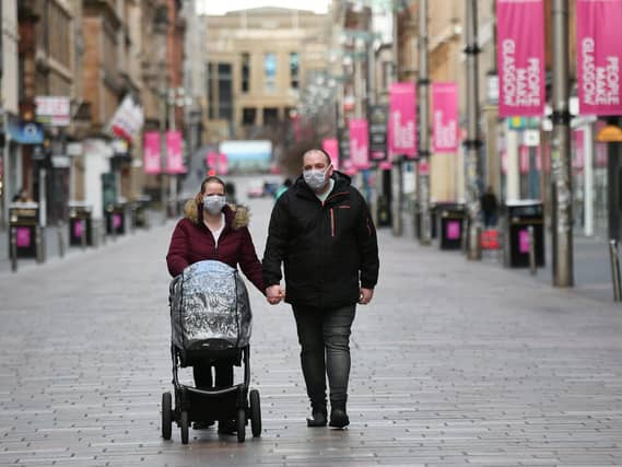A couple on Buchanan Street wearing masks.