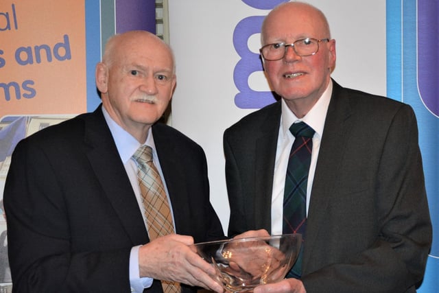 Willie Drysdale (right), who is still competing in veteran events aged 84, picked up this award from Rick Kenny in recognition of 45 years' dedicated service to Law and District Athletics Club.