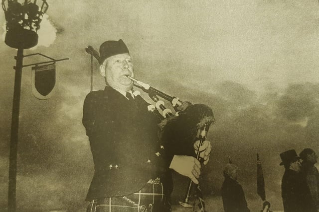 At the Carter Bar, Pipe Major Allan Walker plays the lament at the VE Beacon ceremony.