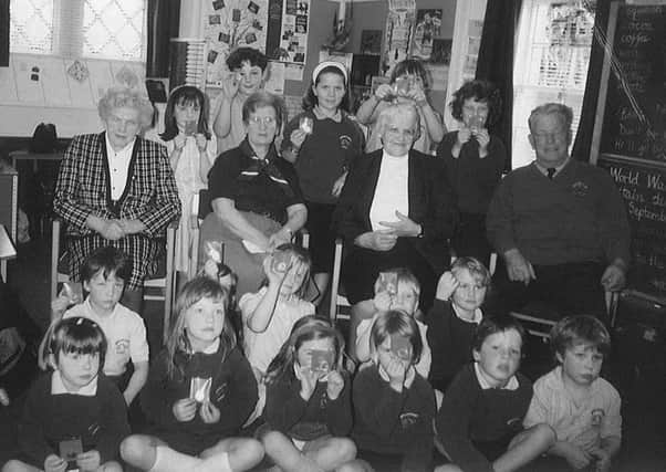 Pupils at Glendouglas Primary School pupils with local war veterans.