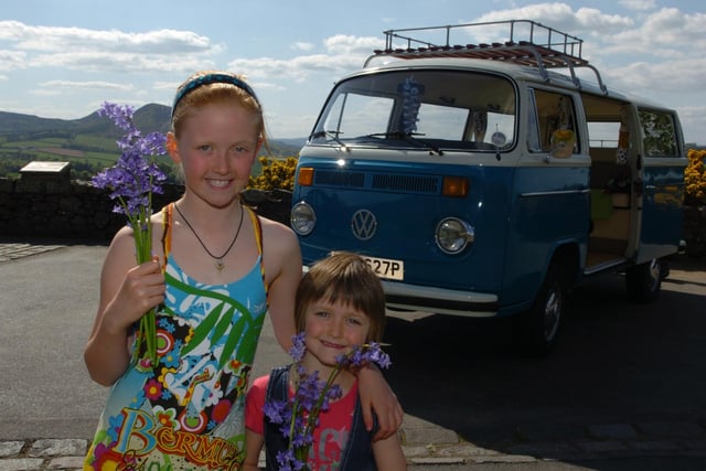 L-r, Rowan and sister Daisey Cunningham winners of naming the campervan competition, which they called 'Bluebell' photographed together holding Bluebell flowers at Scott's View.