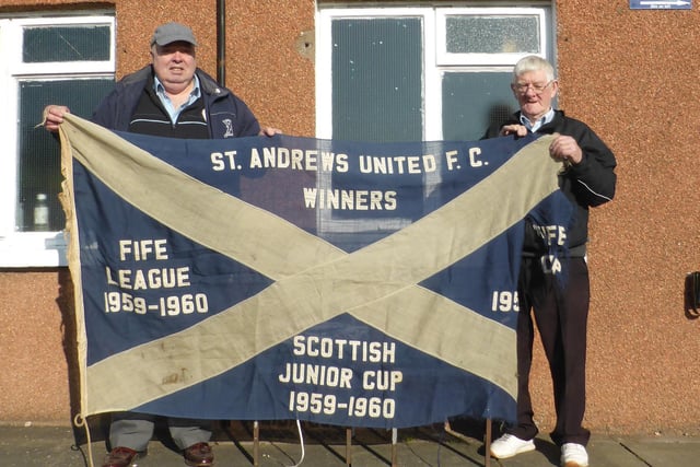 Current Committee members Don Burnett and Ian Donaldson pose with the Championship Flag from 1960