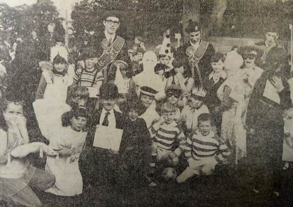 Braw Lad Bruce Dorward and attendants Stuart Keddie and Iain Rackham join children sueing the fancy-dress contest and parade in Scott Park.