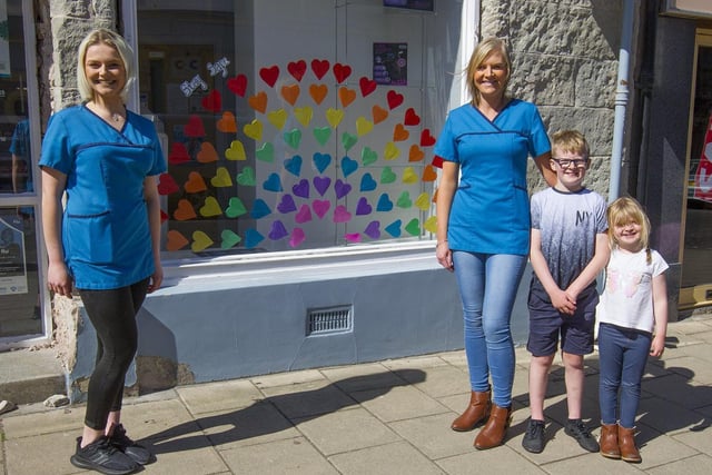 Jedburgh Pharmacy workers Keira French and Nicola Cowe, and her children Jamie and Emma, say thank you NHS with a window display.