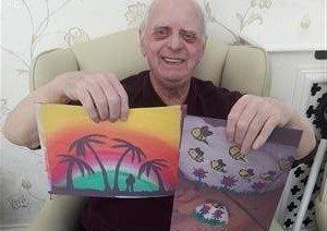 Bobby Pringle's  day is brightened up by a delivery of artwork from children to Bonchester Bridge Care Home.