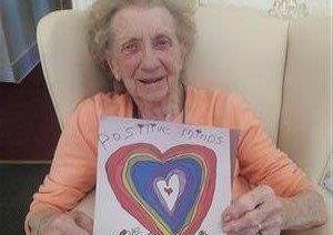 Betty Eliott's  day is brightened up by a delivery of artwork from children to Bonchester Bridge Care Home.