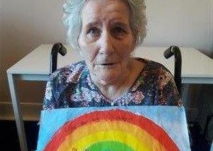 Hannah Mckay's day is brightened up by a delivery of artwork from children to Bonchester Bridge Care Home.