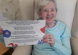 Margaret Rose's day is brightened up by a delivery of artwork from children to Bonchester Bridge Care Home.