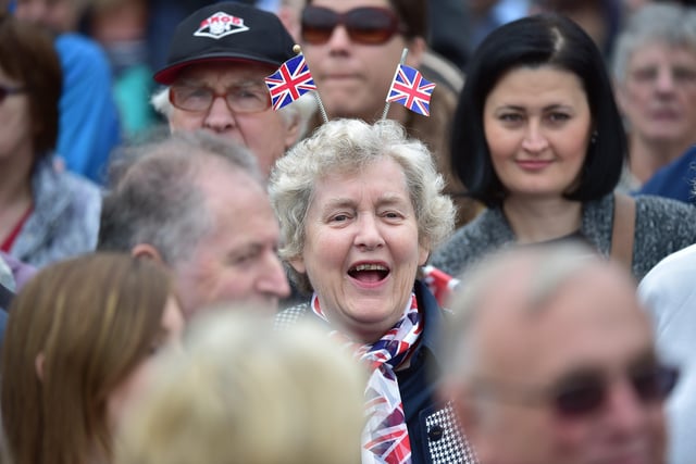 A well-wisher wearing union flags on her head waits to greet Britain's Queen Elizabeth II at Tweedbank on September 9, 2015. (Photo: Leon Neal/AFP via Getty Images)