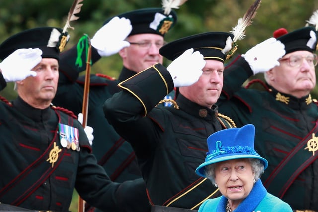 Queen Elizabeth II walks past ceremonial archers as she arrives at Tweedbank.  (Photo by Chris Jackson/Getty Images)