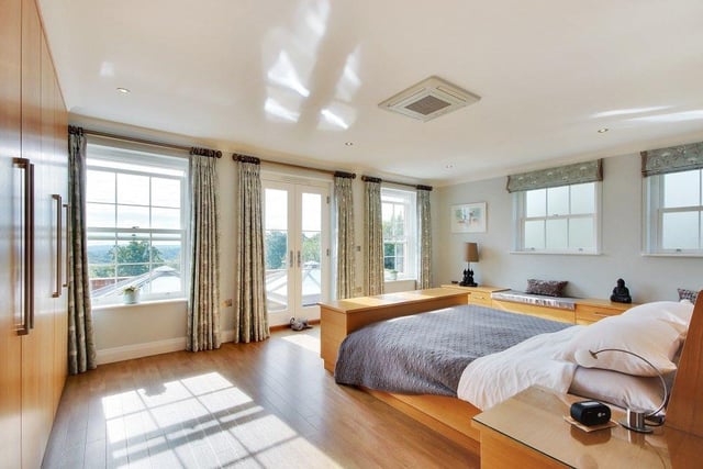 The master bedroom suite is generous, incorporating a dressing room and luxurious bathroom as well as double doors opening out to a balcony with views to the south.