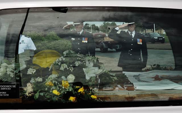 Mourners attend the funeral of Will Baker